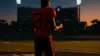College quarterback at crossroads between college and NFL football field under dramatic stadium lights