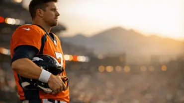 Broncos backup quarterback on sideline contemplating trade opportunity during NFL game
