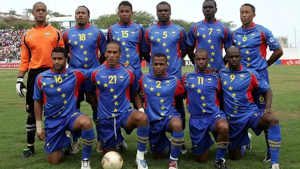 Cape Verde national football team players posing in their blue kit with stars.
