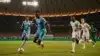 Cape Verde player sprinting with ball during World Cup match against Saudi Arabia in packed stadium