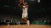 NBA forward player shooting basketball in arena with green team colors and professional lighting