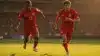 Spanish football players attacking in red jerseys during World Cup match