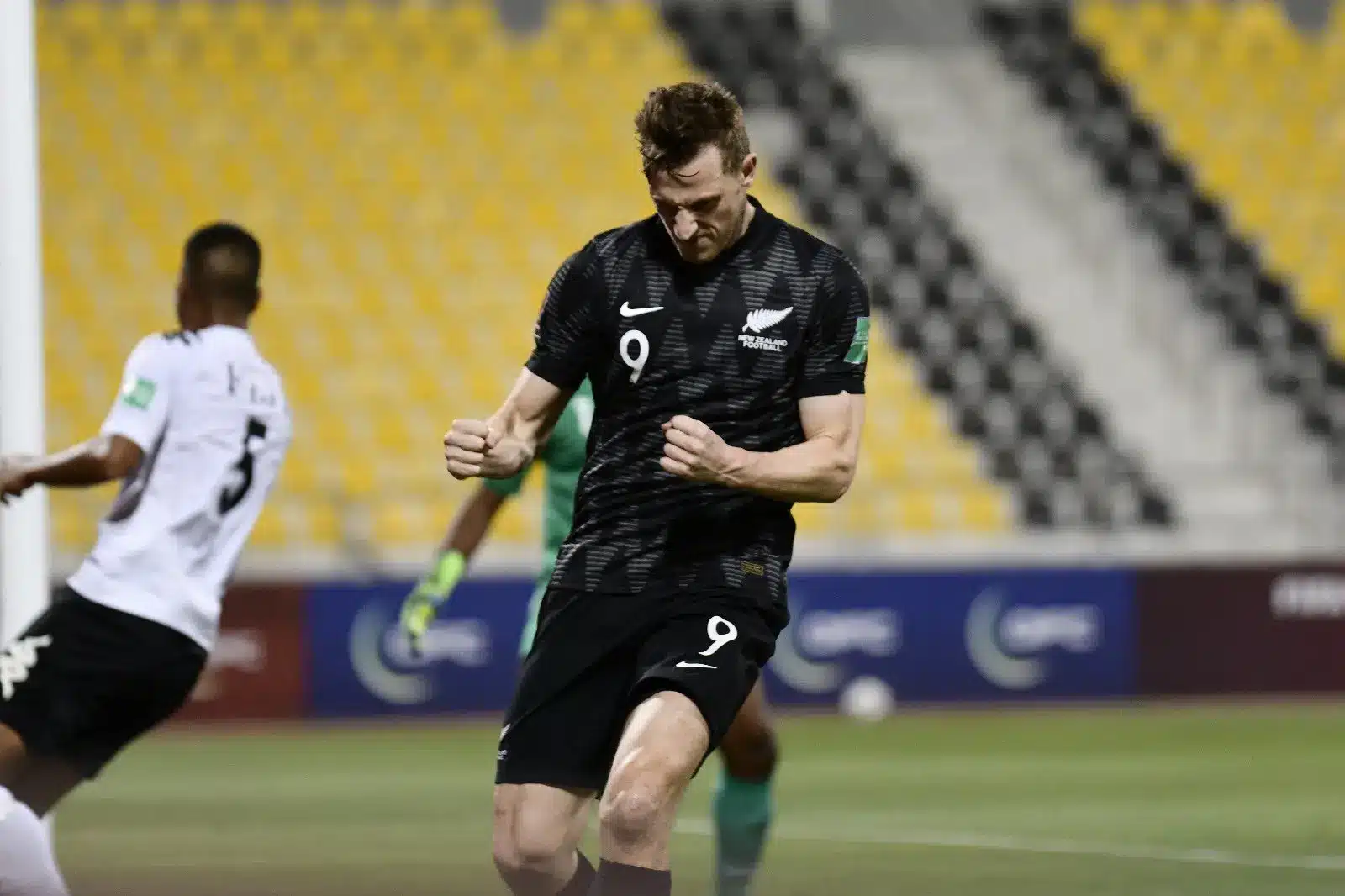 New Zealand football player celebrating a goal during a match.