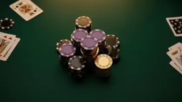 Luxury poker table with premium chips and cards under dramatic lighting