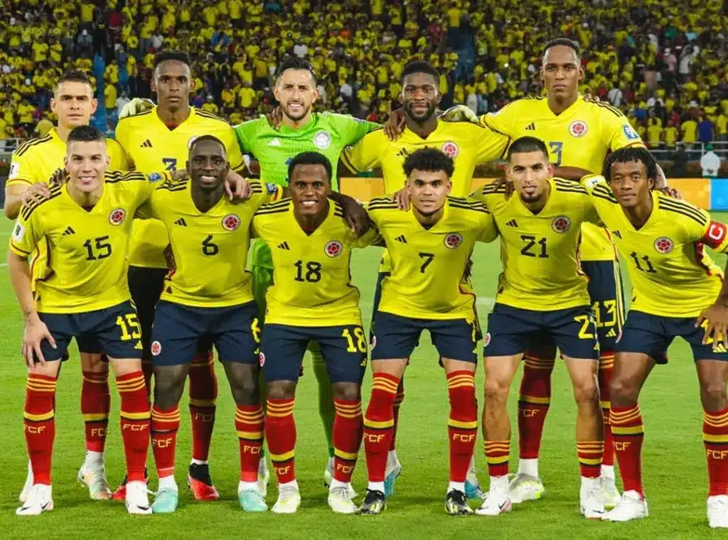 Colombia national football team posing for a photo in yellow jerseys.
