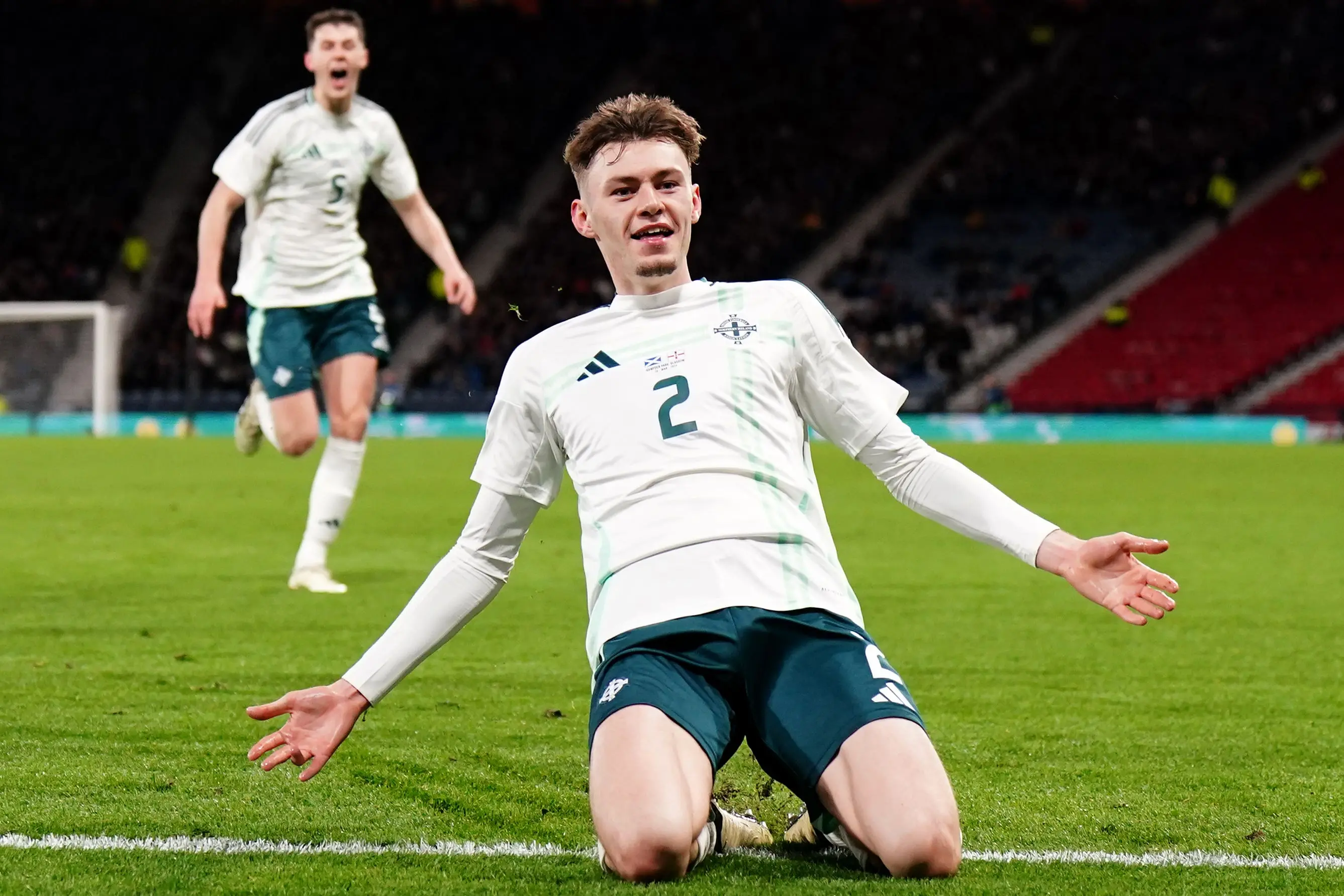 Conor Bradley celebrating on the pitch during a Northern Ireland football match