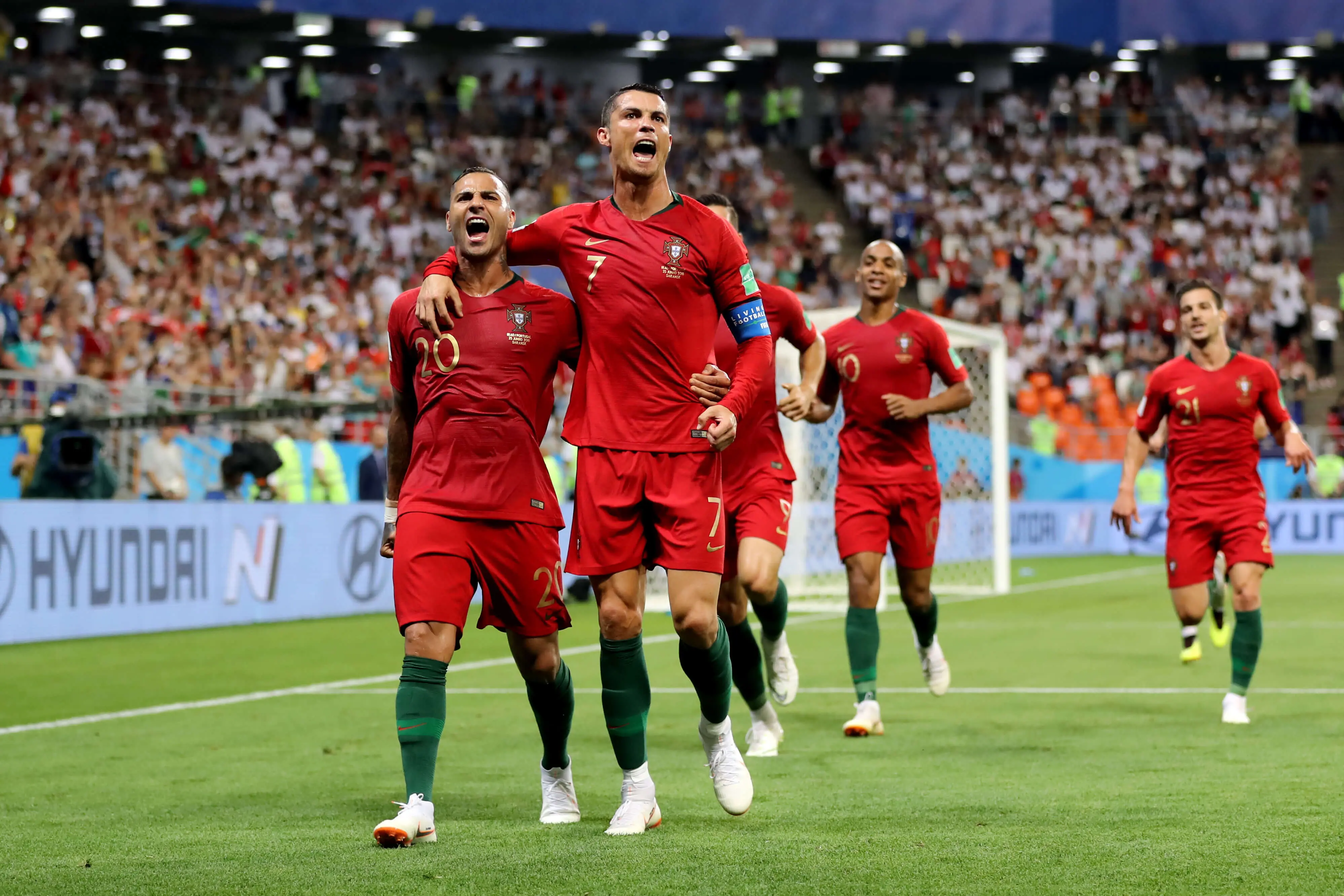 Cristiano Ronaldo celebrating with teammates during a match for Portugal.