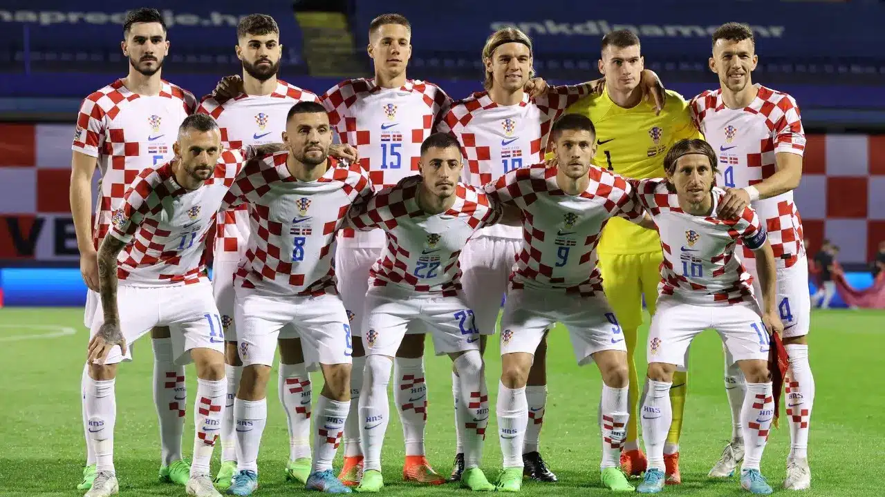 Croatia national football team players posing in their home kit during a match.