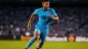 Uruguay striker in sky blue jersey sprinting during World Cup match at Hard Rock Stadium