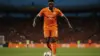 Ivory Coast soccer player in orange jersey during World Cup match action at Lincoln Financial Field