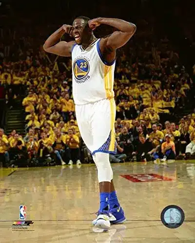 Draymond Green celebrating in his Golden State Warriors jersey during a game.