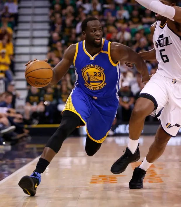 Draymond Green dribbling the ball during a game for the Golden State Warriors.