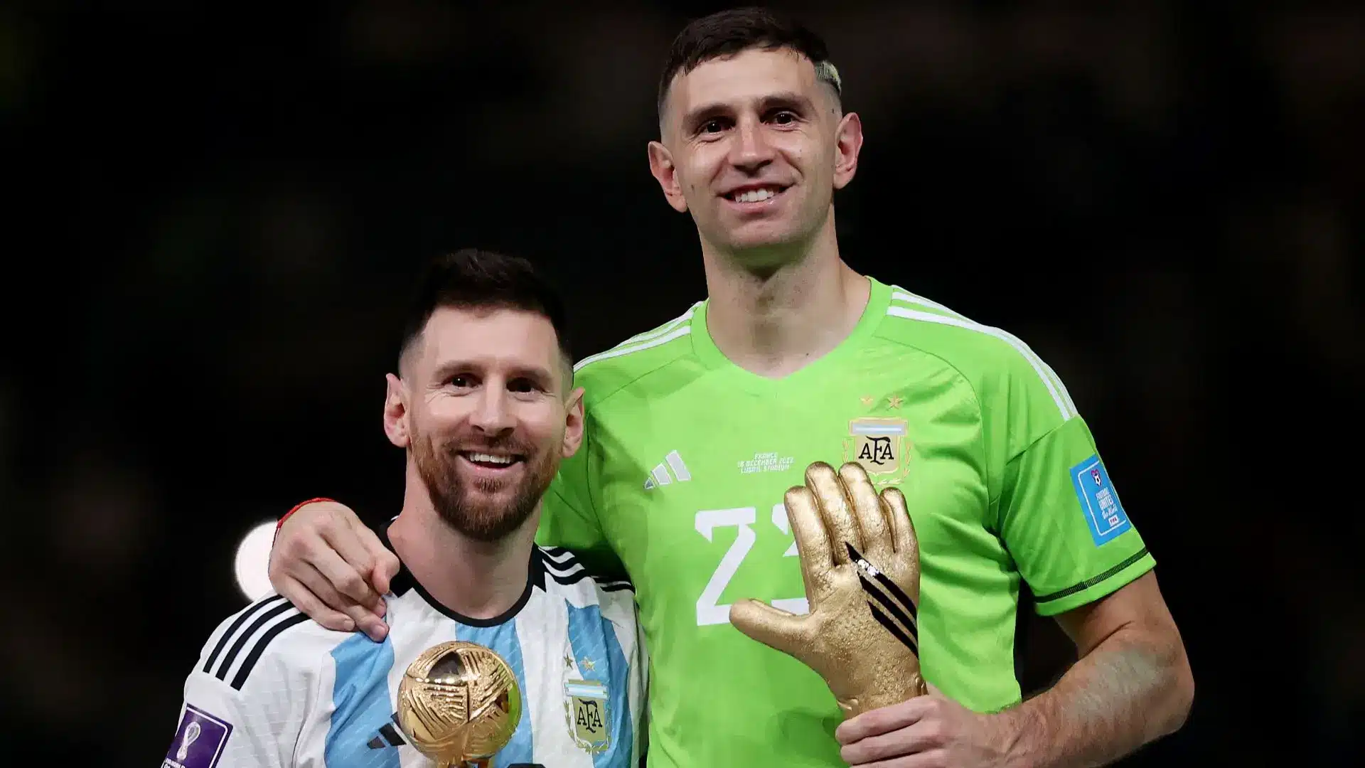 Emiliano Martinez and Lionel Messi celebrating after winning the 2022 FIFA World Cup.
