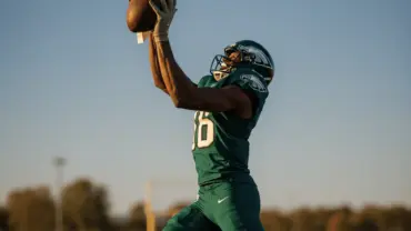 Wide receiver in Eagles uniform making leaping catch during training camp practice