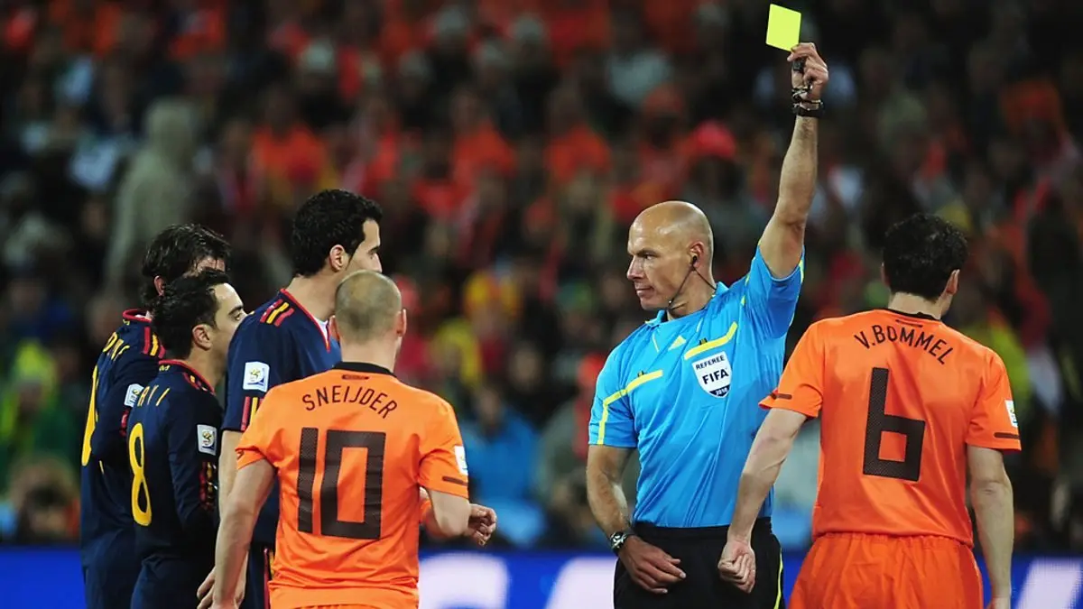 Referee shows a yellow card during a FIFA World Cup match.