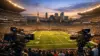 NFL stadium in Mexico City filled with fans at twilight with broadcast cameras on sideline