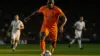 Netherlands striker attacking in orange jersey during World Cup match against Tunisia
