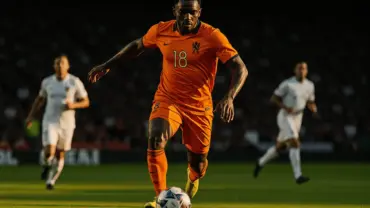 Netherlands striker attacking in orange jersey during World Cup match against Tunisia