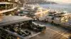Elevated view of Monaco Grand Prix paddock with Mercedes garage and harbor background
