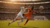 Germany player shooting on goal against Ivory Coast defender in World Cup match action shot