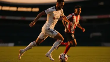 Germany player dribbling soccer ball against Paraguay defender at Gillette Stadium World Cup match