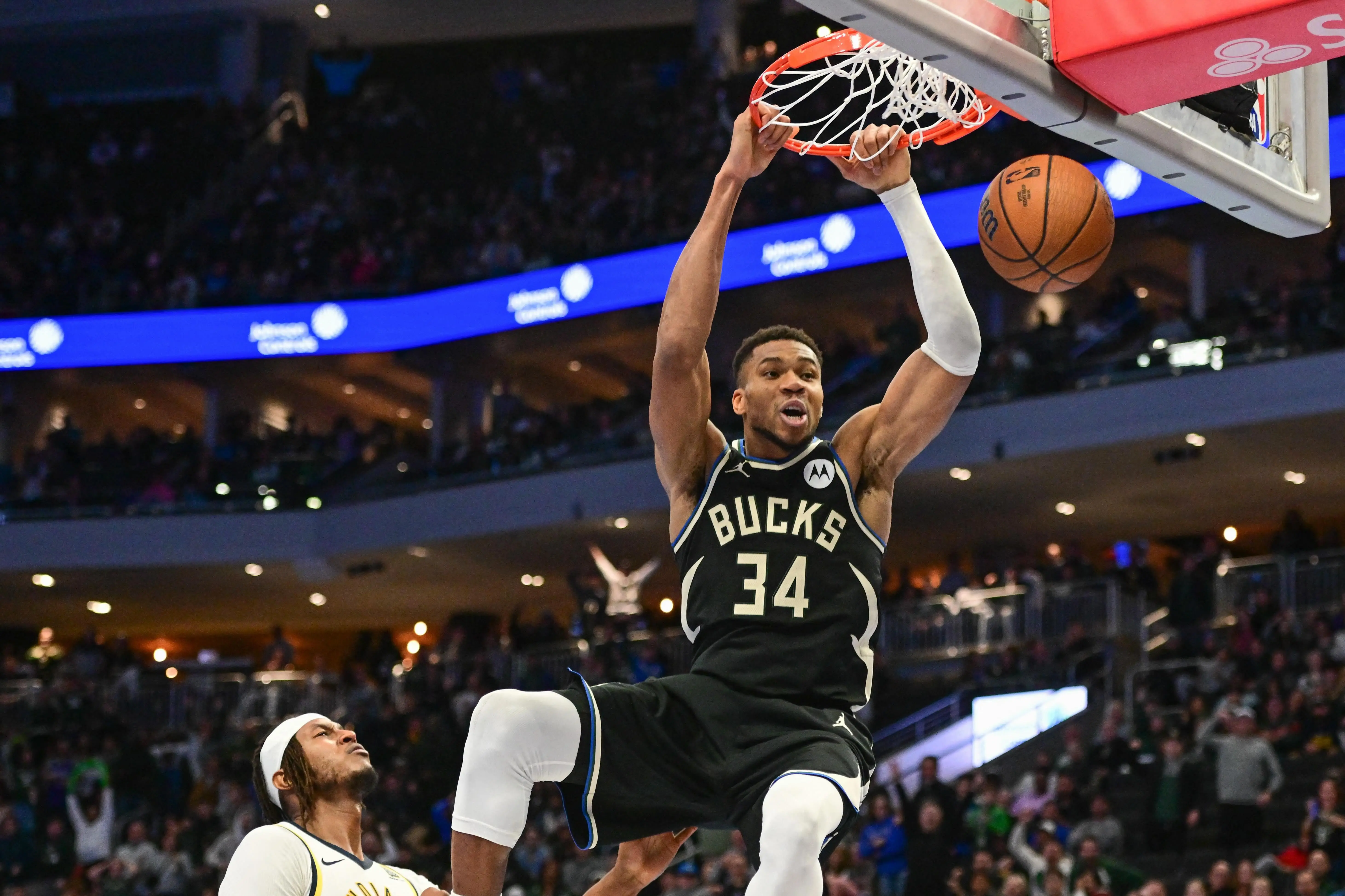 Giannis Antetokounmpo dunking during a Milwaukee Bucks game.