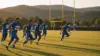 New York Giants receivers running routes during minicamp practice with kicker and training facility backdrop