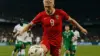 Erling Haaland shooting for Norway against Senegal defenders in World Cup match under stadium lights