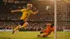 Norway striker leaping to shoot during intense World Cup match against Ivory Coast goalkeeper