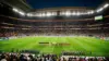 Football teams lined up on illuminated stadium pitch during World Cup match pre-ceremony at night
