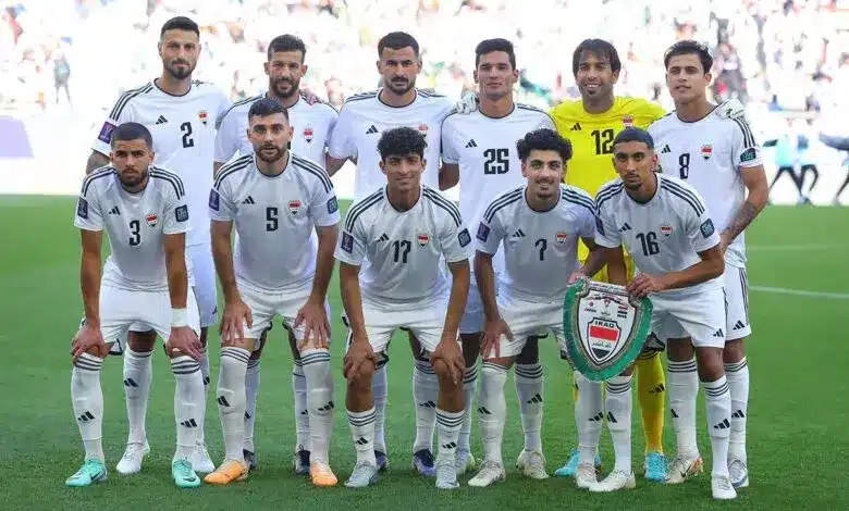 Iraq national football team posing for a team photo in uniforms.