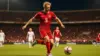 Norwegian striker in red kit shoots on goal during intense World Cup match at stadium