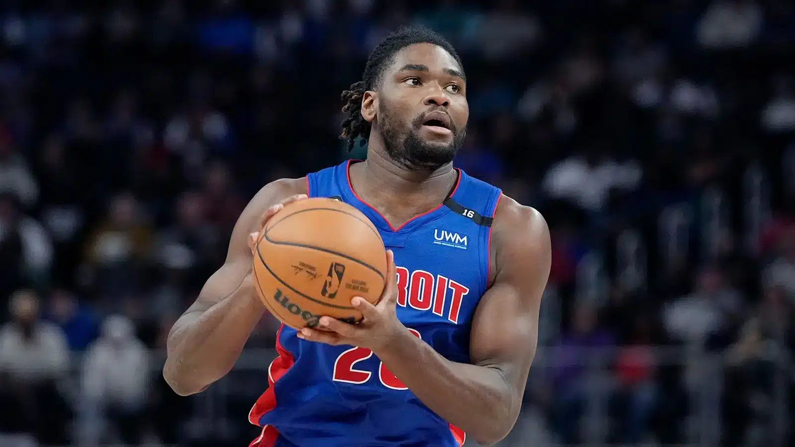 Isaiah Stewart of the Detroit Pistons holding a basketball during a game.