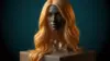 Blonde wig on display pedestal with dramatic lighting against teal background representing Trevor Lawrence collectible