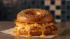 Bacon egg and cheese everything bagel with hashbrowns at New York bodega counter