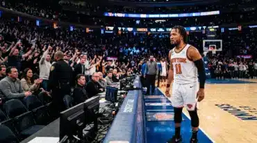 Jalen Brunson in Knicks jersey standing courtside after NBA Finals game in tense postgame moment