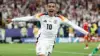 Jamal Musiala celebrating in Germany's football kit during a match.