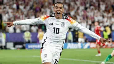 Jamal Musiala celebrating in Germany's football kit during a match.