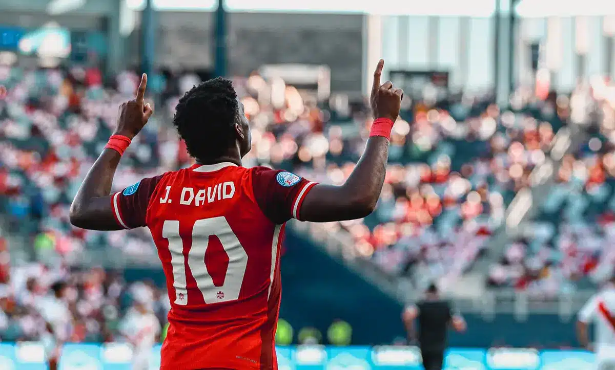 Soccer player J. David celebrating during a match for Canada.
