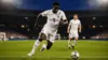 England striker attacking toward goal during World Cup match with dramatic stadium lighting