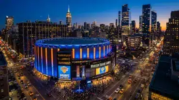 Madison Square Garden illuminated at dusk with championship atmosphere in New York City