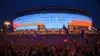 Madison Square Garden lit up at night with massive crowd celebrating Knicks championship victory