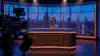 Tonight Show studio set with NBA championship trophy under stage lights and New York City skyline backdrop