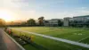 Empty 49ers practice facility bathed in golden hour light showing earned rest after perfect attendance