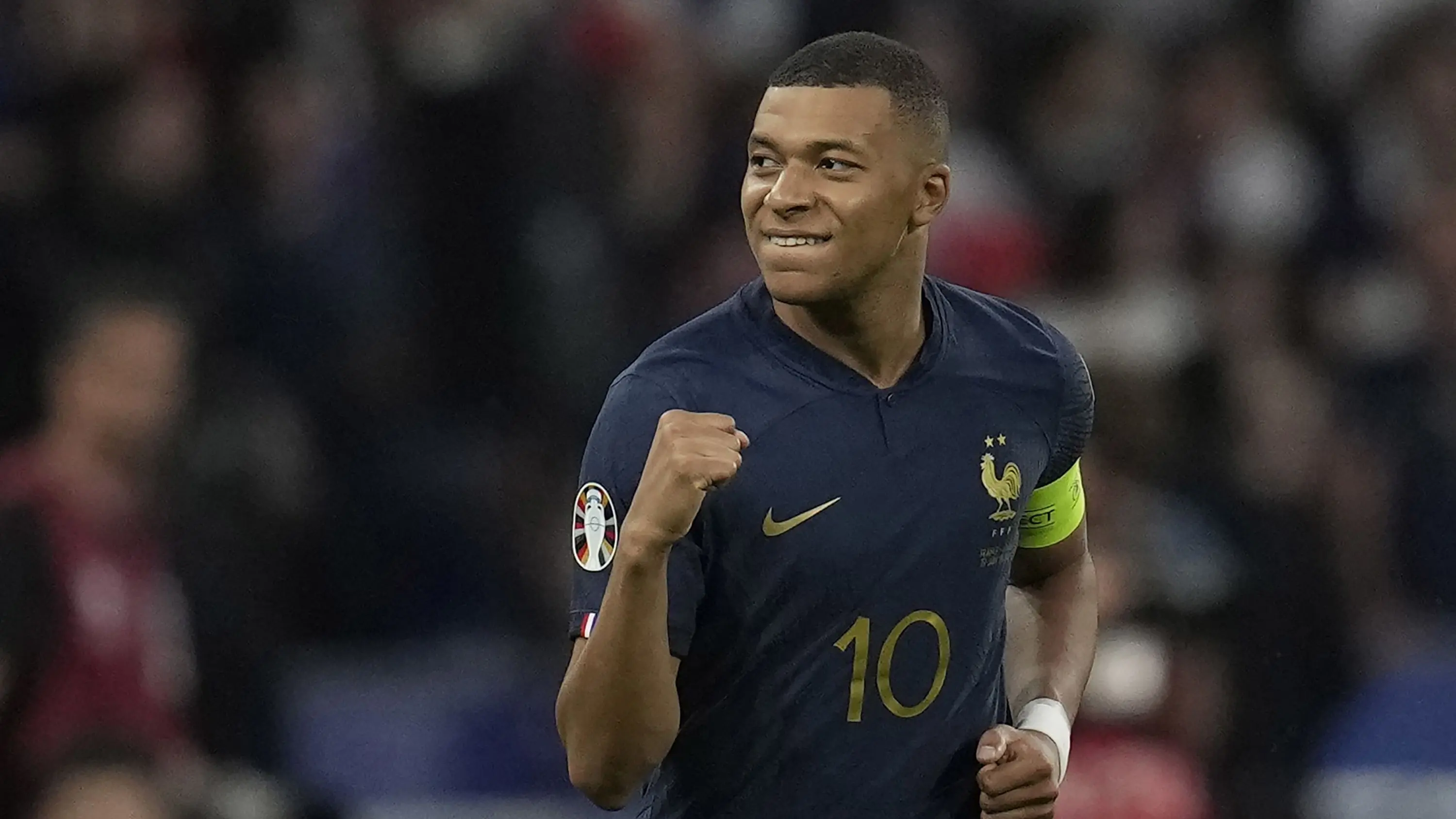 Kylian Mbappé celebrating a goal for France in a football match.