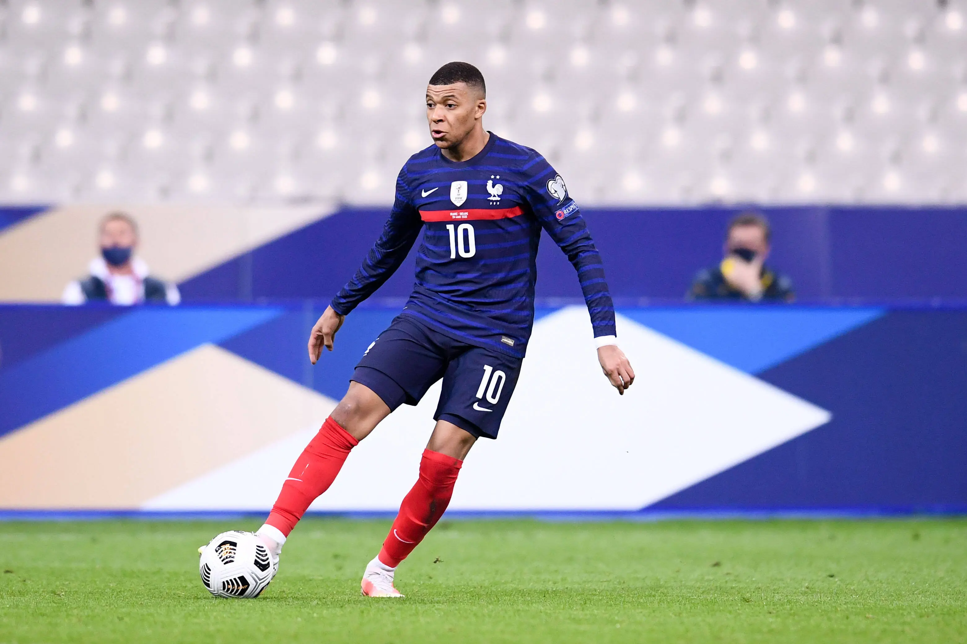 Kylian Mbappe in action wearing the France national team kit during a match.