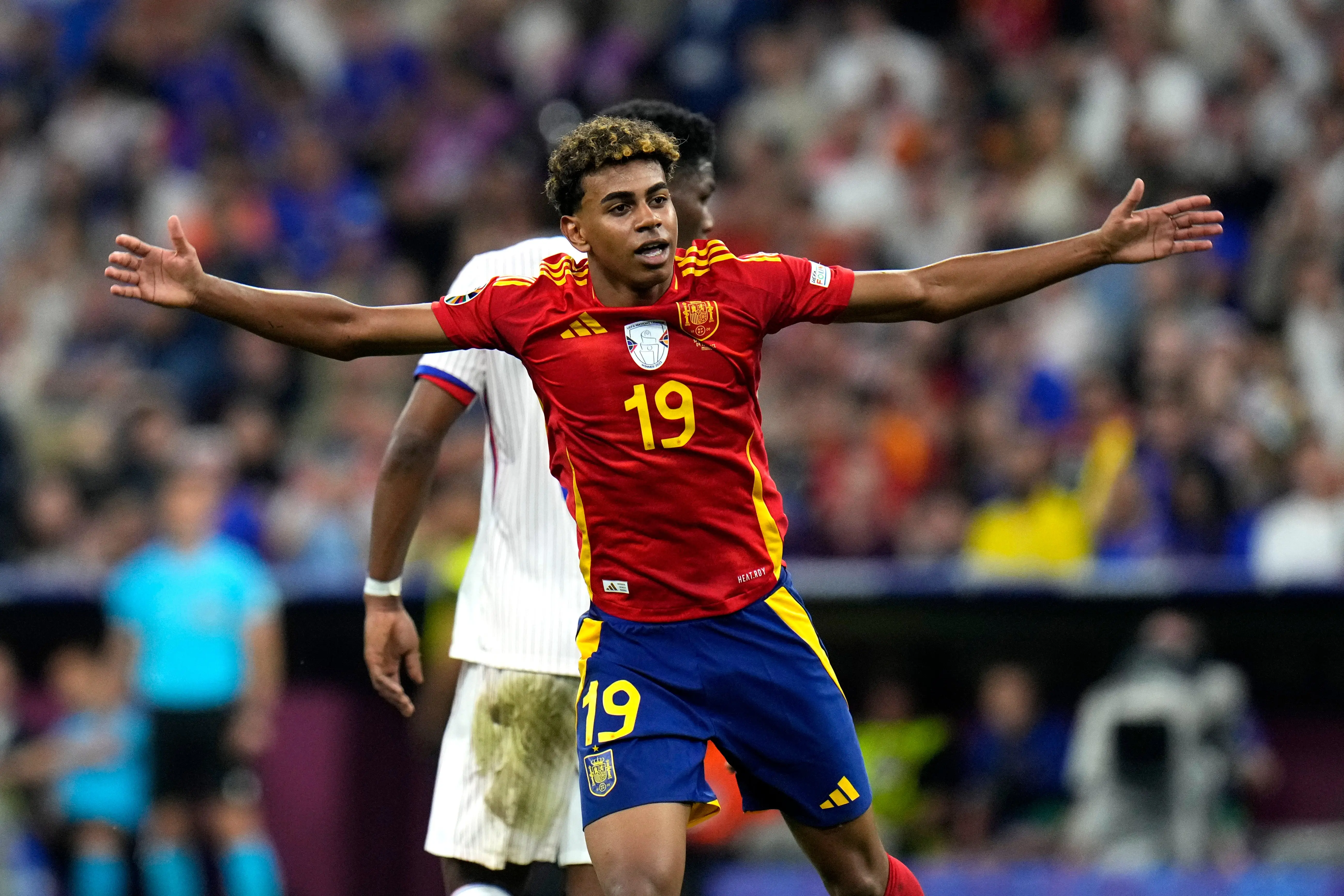 Lamine Yamal celebrating during a Spain football match, wearing the national team jersey.