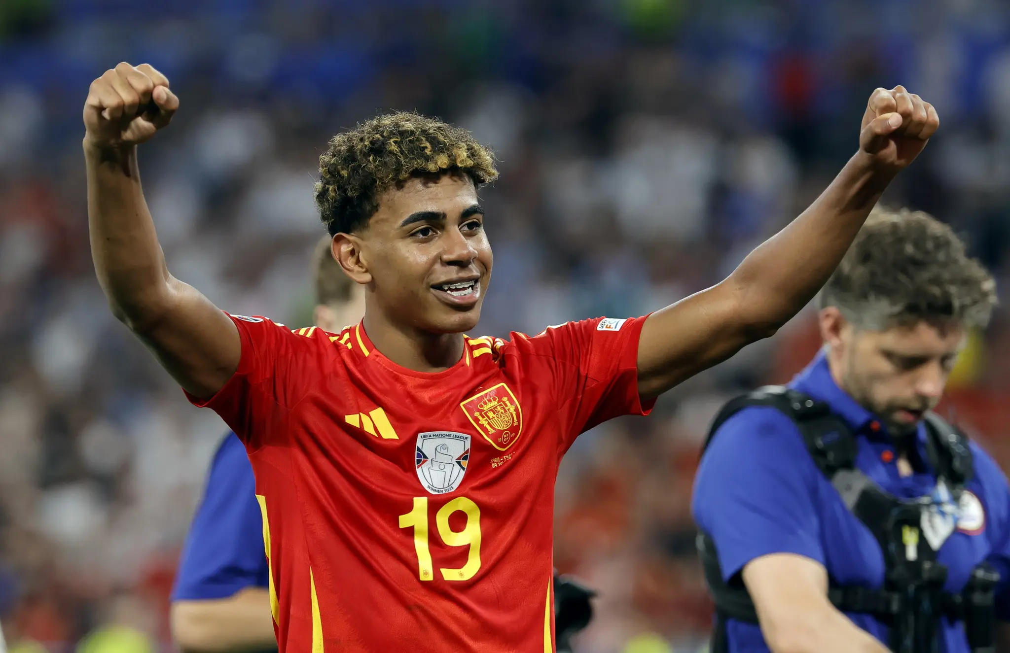 Lamine Yamal celebrating in Spain national team jersey during a match.