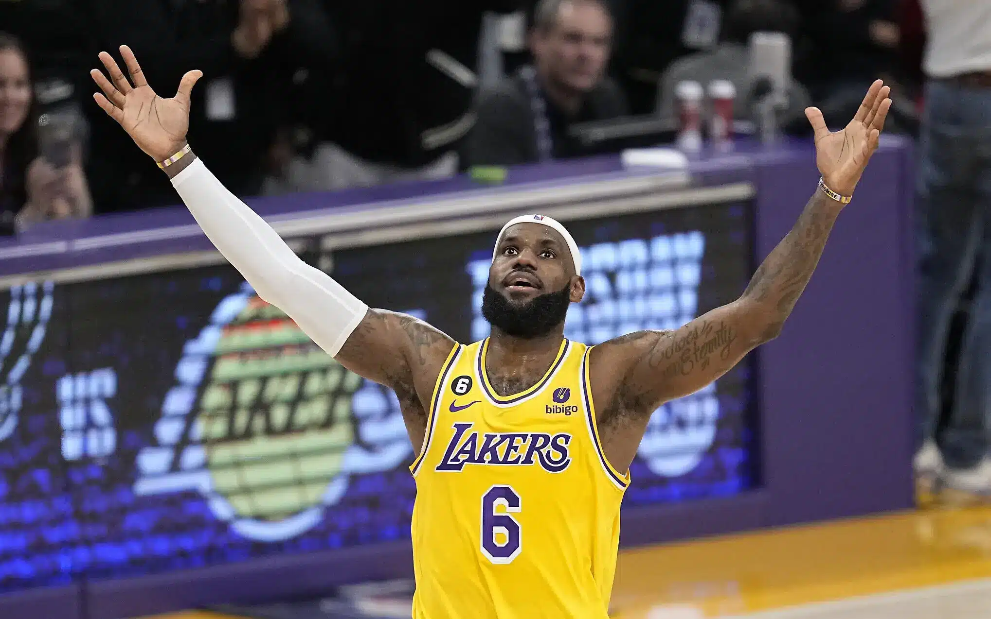 LeBron James celebrating in a Los Angeles Lakers jersey during a game.