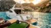 Luxury yacht on Mediterranean waters near Italian coast with golf club on deck